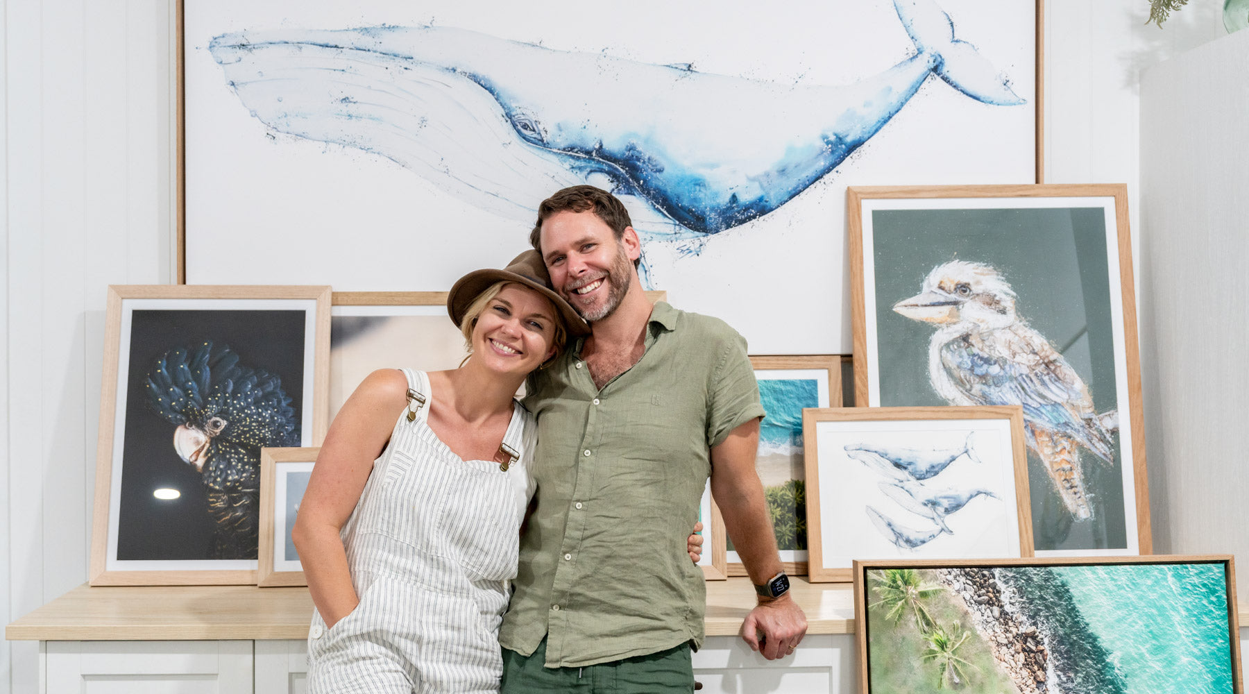 Stephanie Elizabeth and David Lloyd in front of photography and artwork