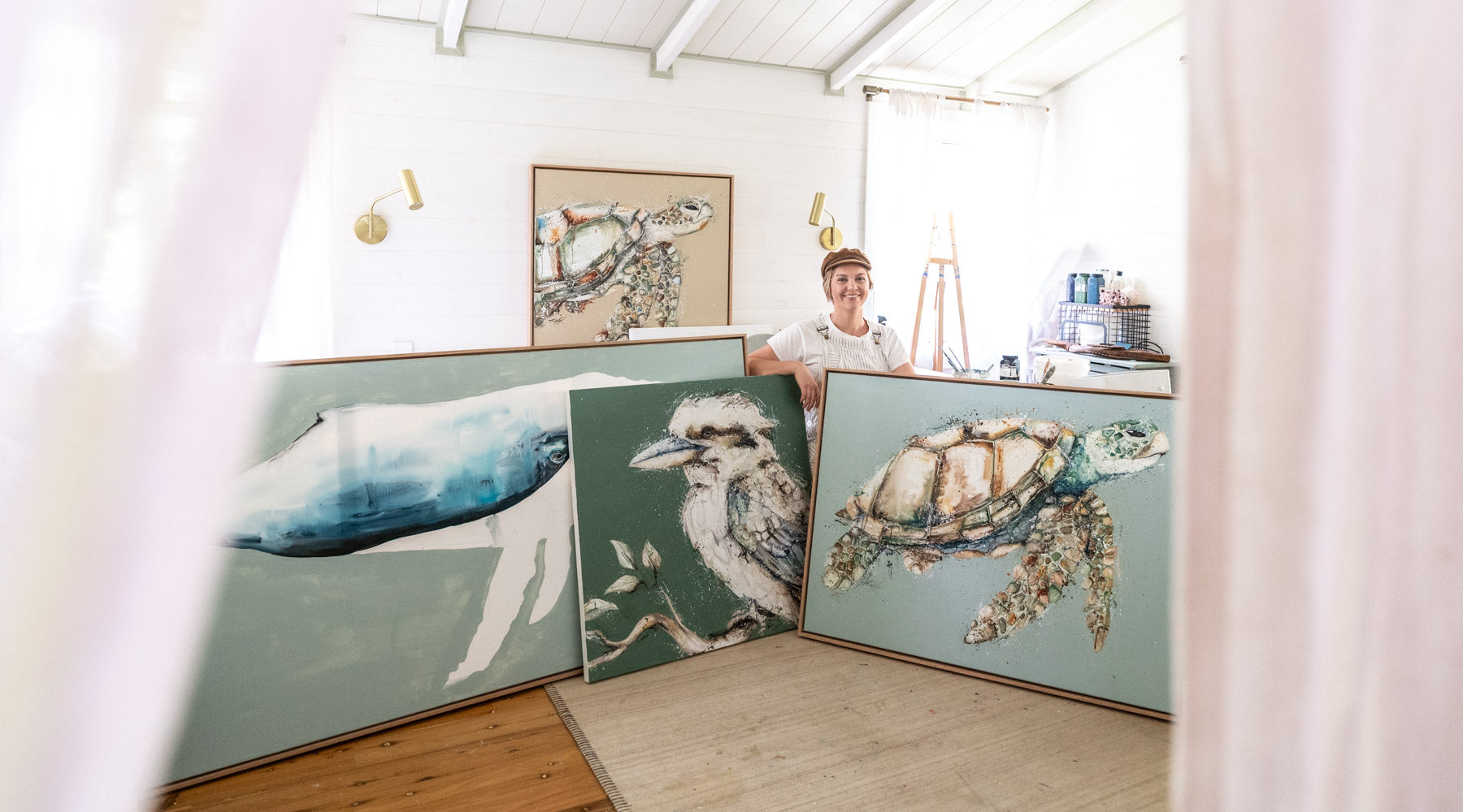 Stephanie Elizabeth surrounded by original artwork