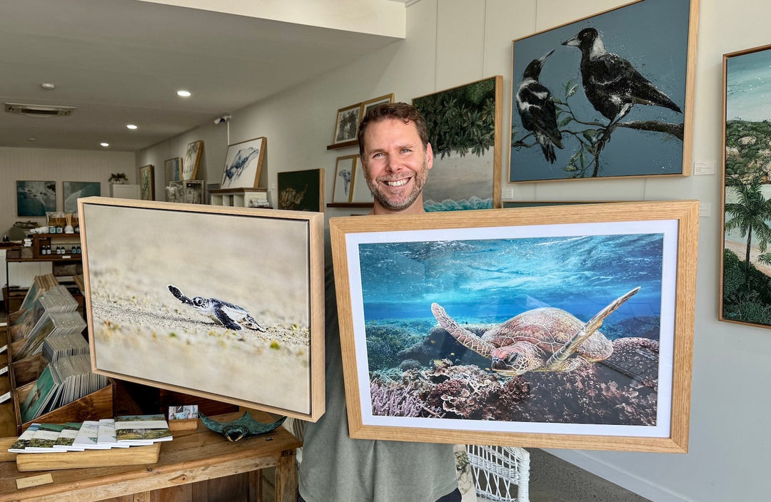 David Lloyd holding a paper print and a canvas print