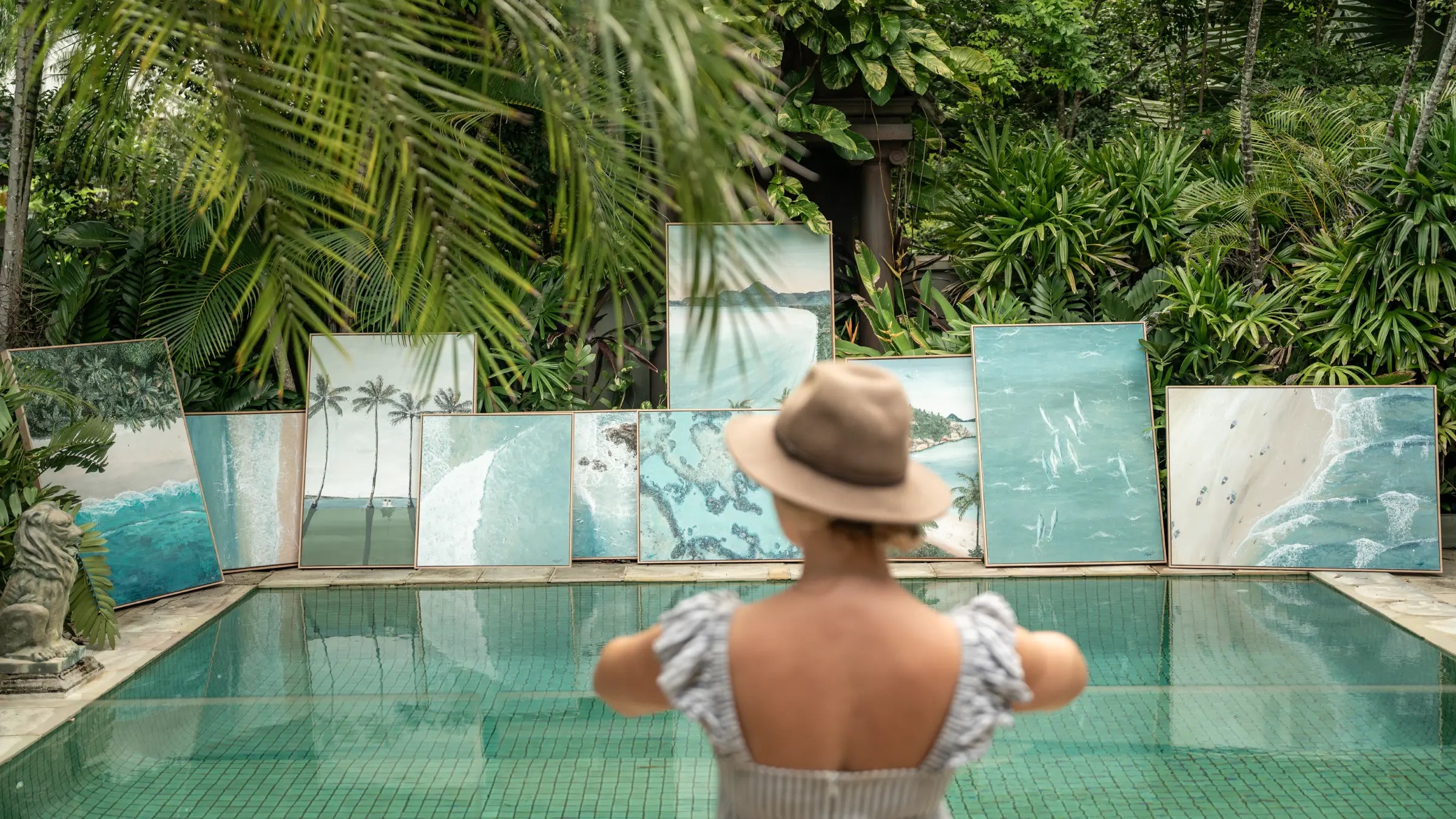 Stephanie Elizabeth coastal fine art collection displayed beside a tropical pool surrounded by lush rainforest gardens