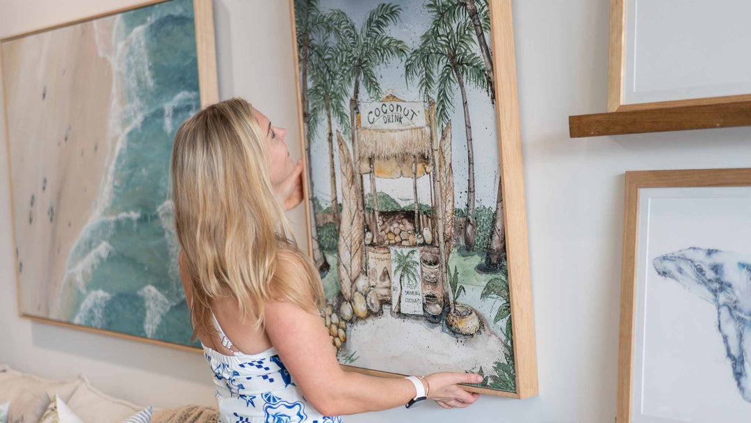 Stephanie Elizabeth coastal fine art collection displayed beside a tropical pool surrounded by lush rainforest gardens