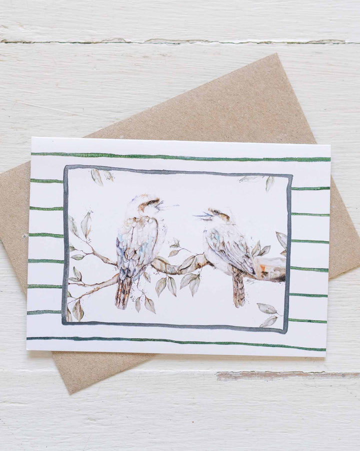 Branching Out Together greeting card with two kookaburras on striped background, paired with a brown envelope.