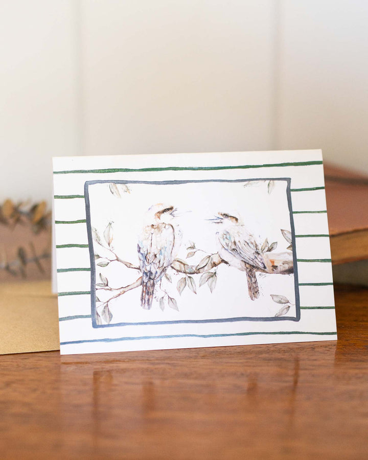 Branching Out Together“ greeting card with two birds perched on branches and green striped background.