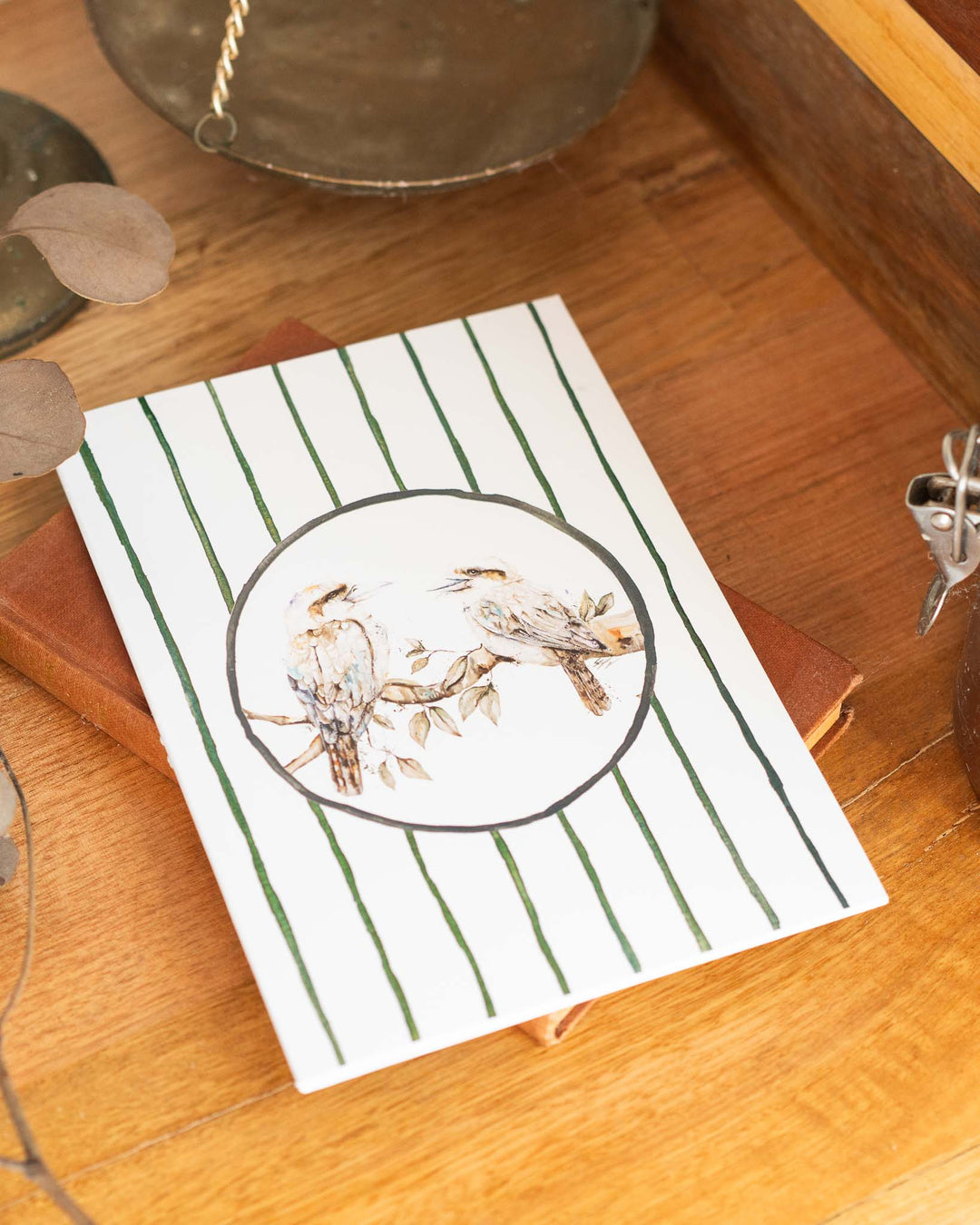 “Branching Out Together” A5 notebook featuring two kookaburras on a cover with green stripes.