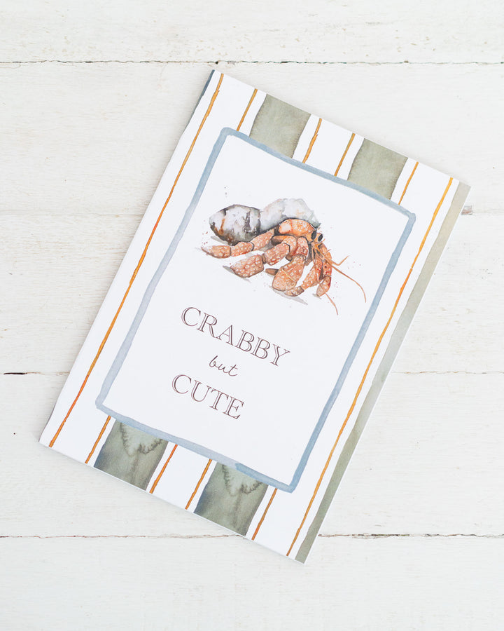 Crabby but Cute“ A5 lined notebook with a whimsical crab illustration on the cover.