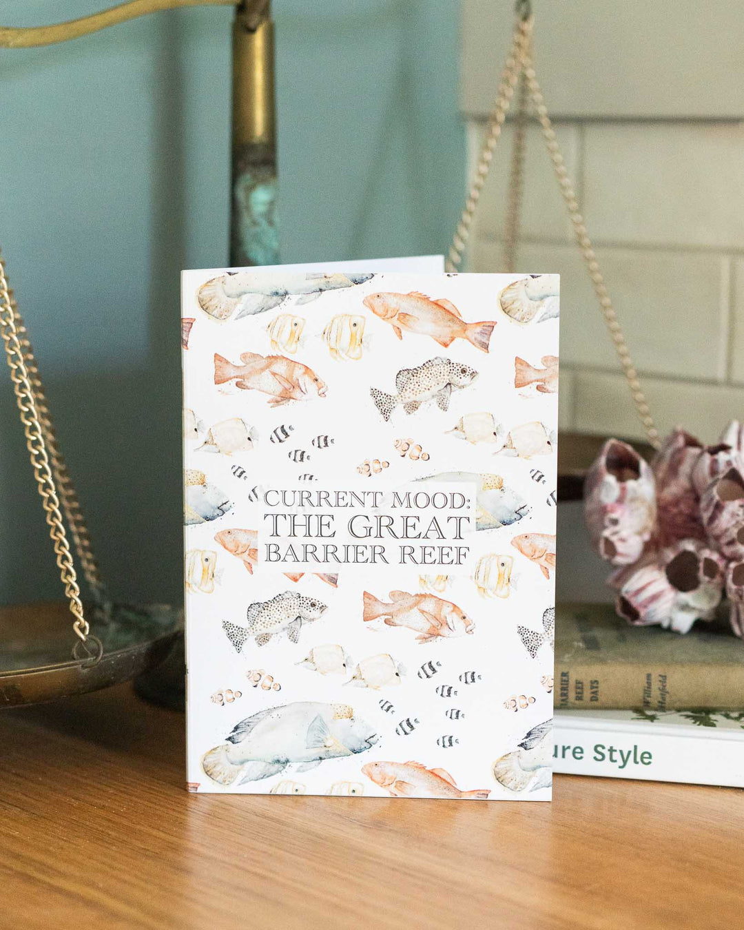 Current Mood: The Great Barrier Reef A5 lined notebook on a wooden table.