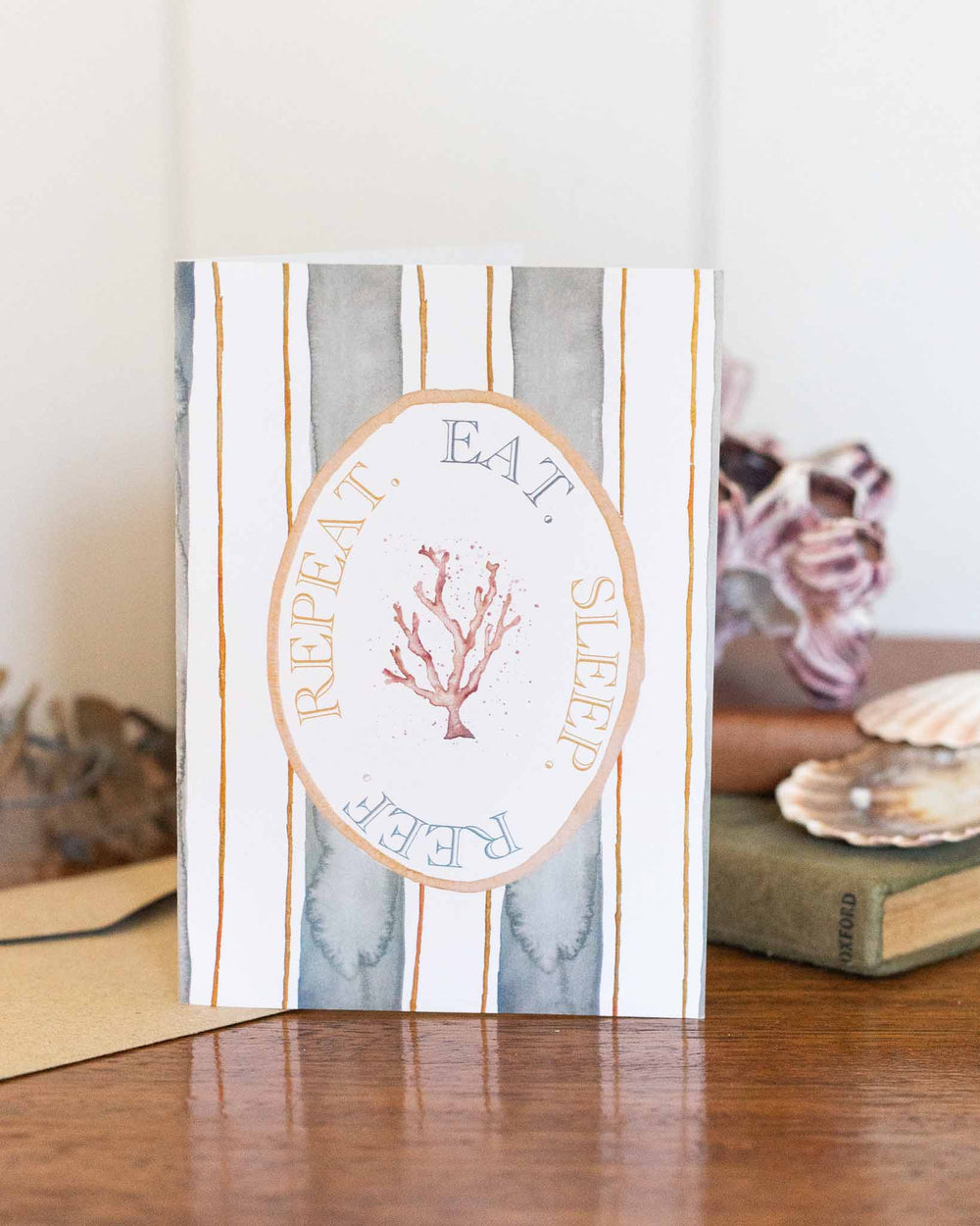 Eat Sleep Reef Repeat card with coral illustration and the phrase: EAT. SLEEP. REEF. REPEAT.