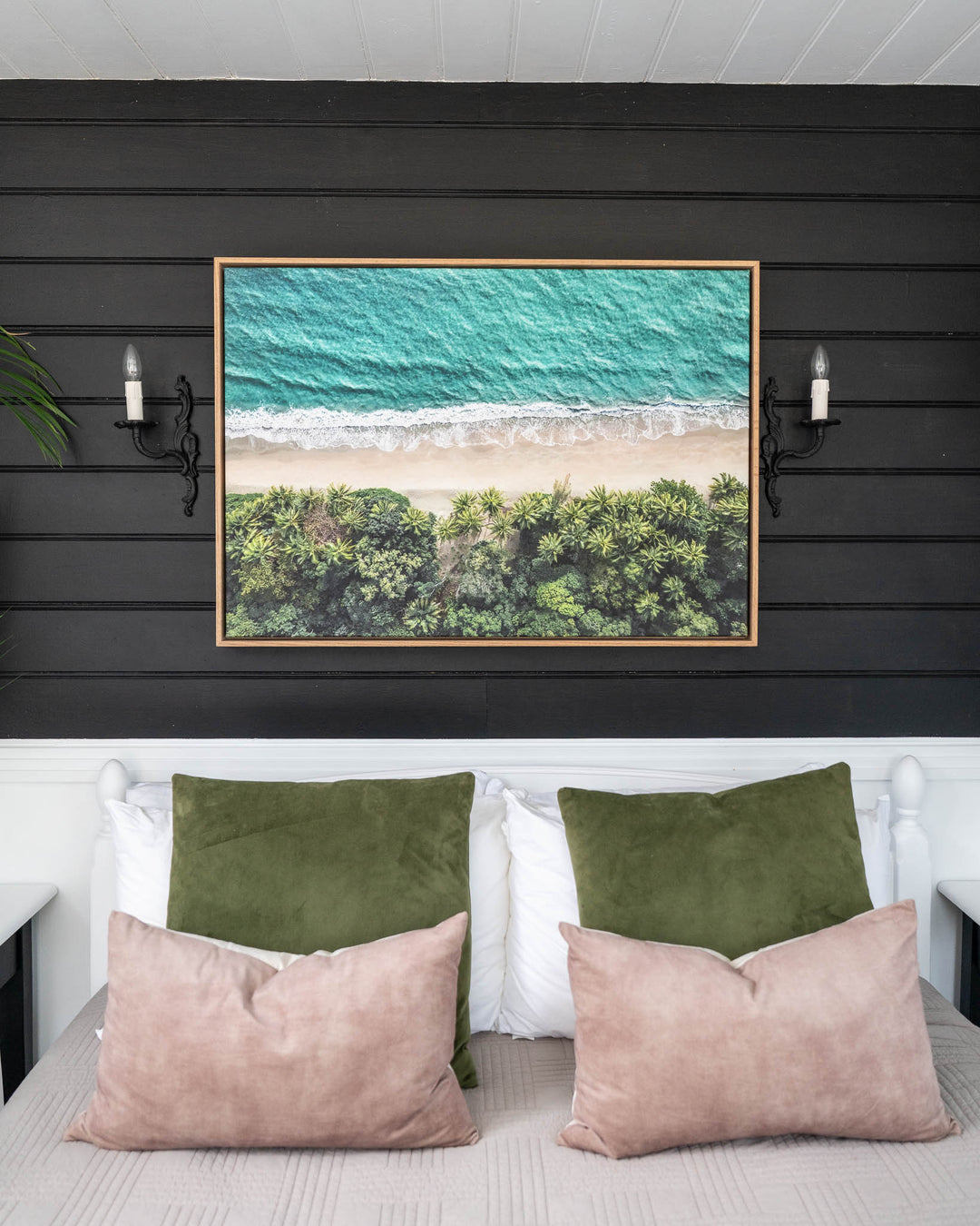 Emerald Tide aerial print of Four Mile Beach framed and displayed as wall art above a bed.