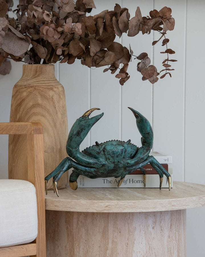 XL Crab in aged brass on a stone table, styled with books and dried leaves for a coastal look.