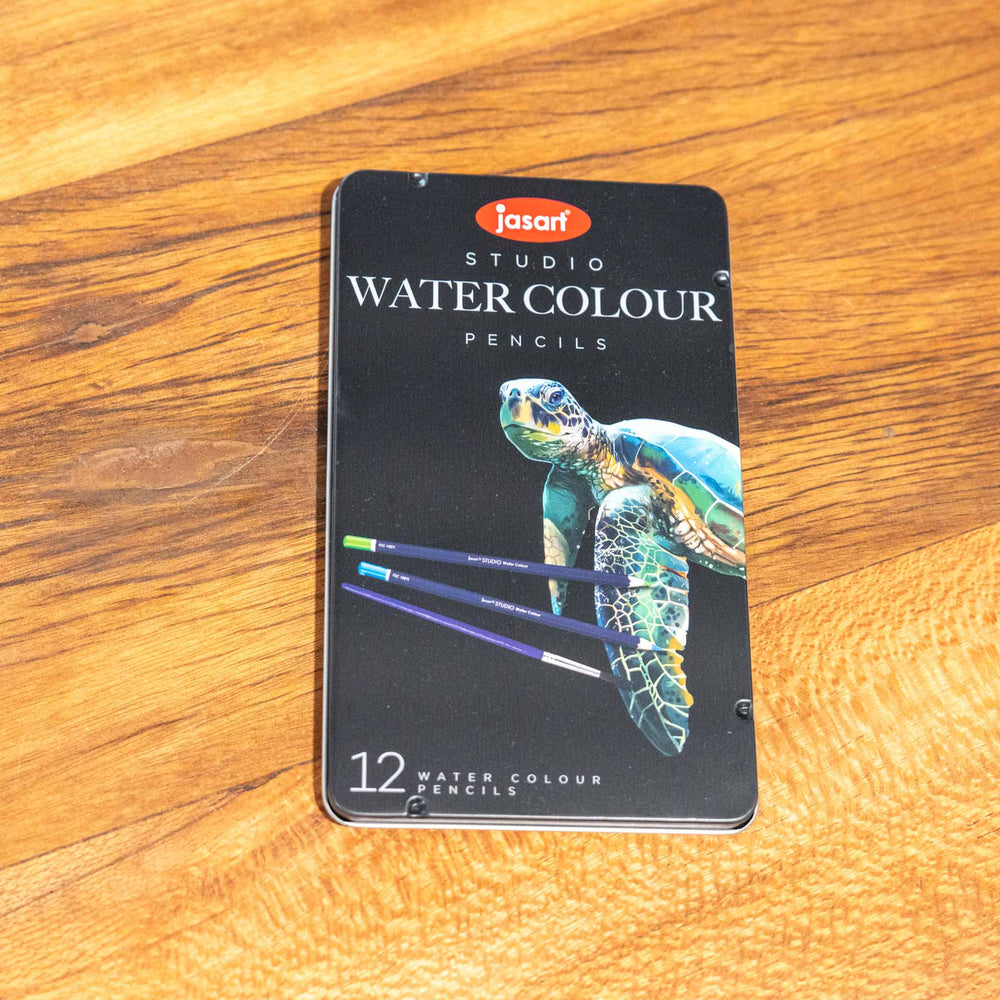 SEA Gallery Jasart 12 Watercolour Pencil Set in turtle-themed packaging, displayed on a wooden surface.