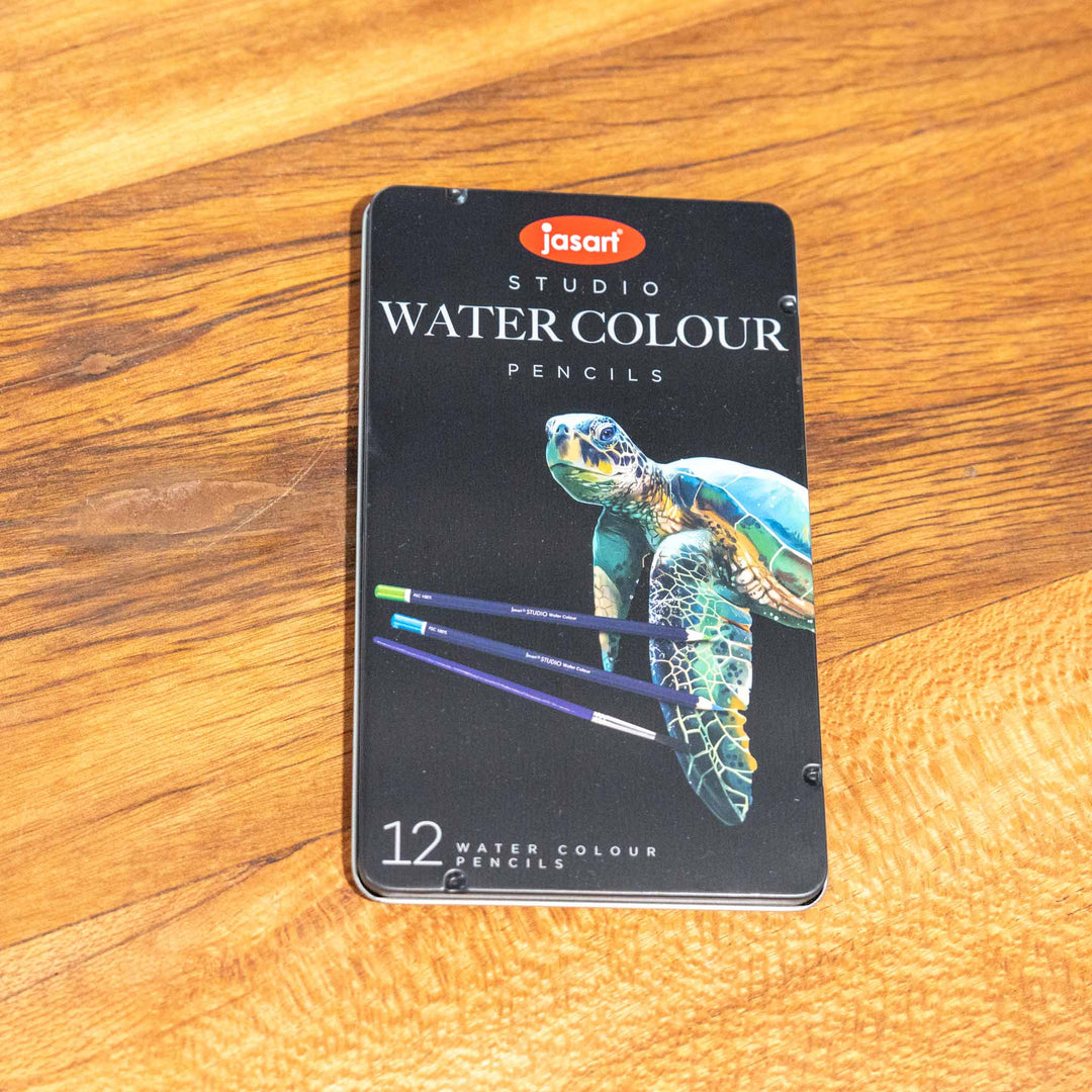 SEA Gallery Jasart 12 Watercolour Pencil Set in turtle-themed packaging, displayed on a wooden surface.