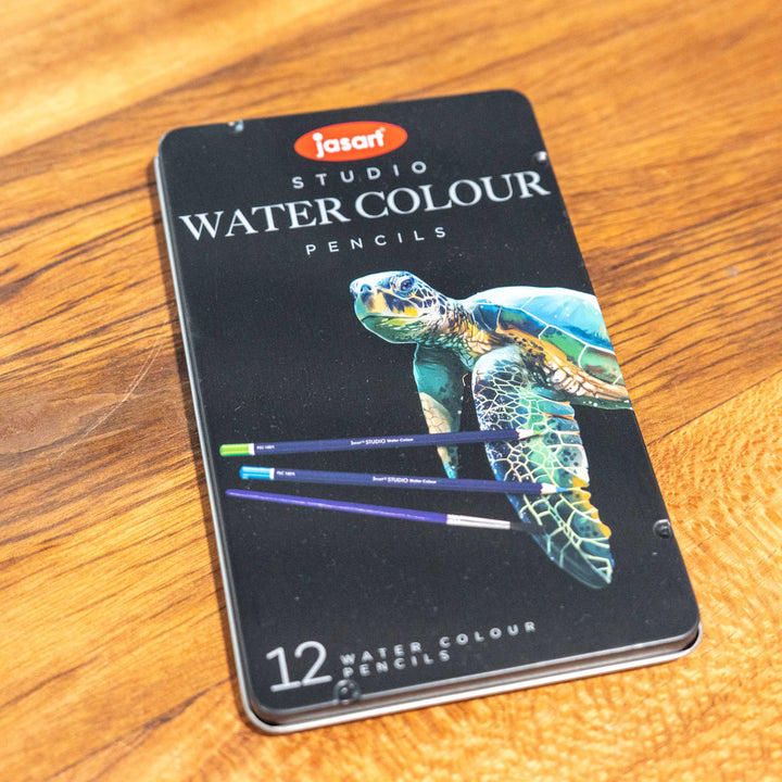 SEA Gallery Jasart 12 Watercolour Pencil Set featuring a turtle illustration, displayed on a wooden surface.
