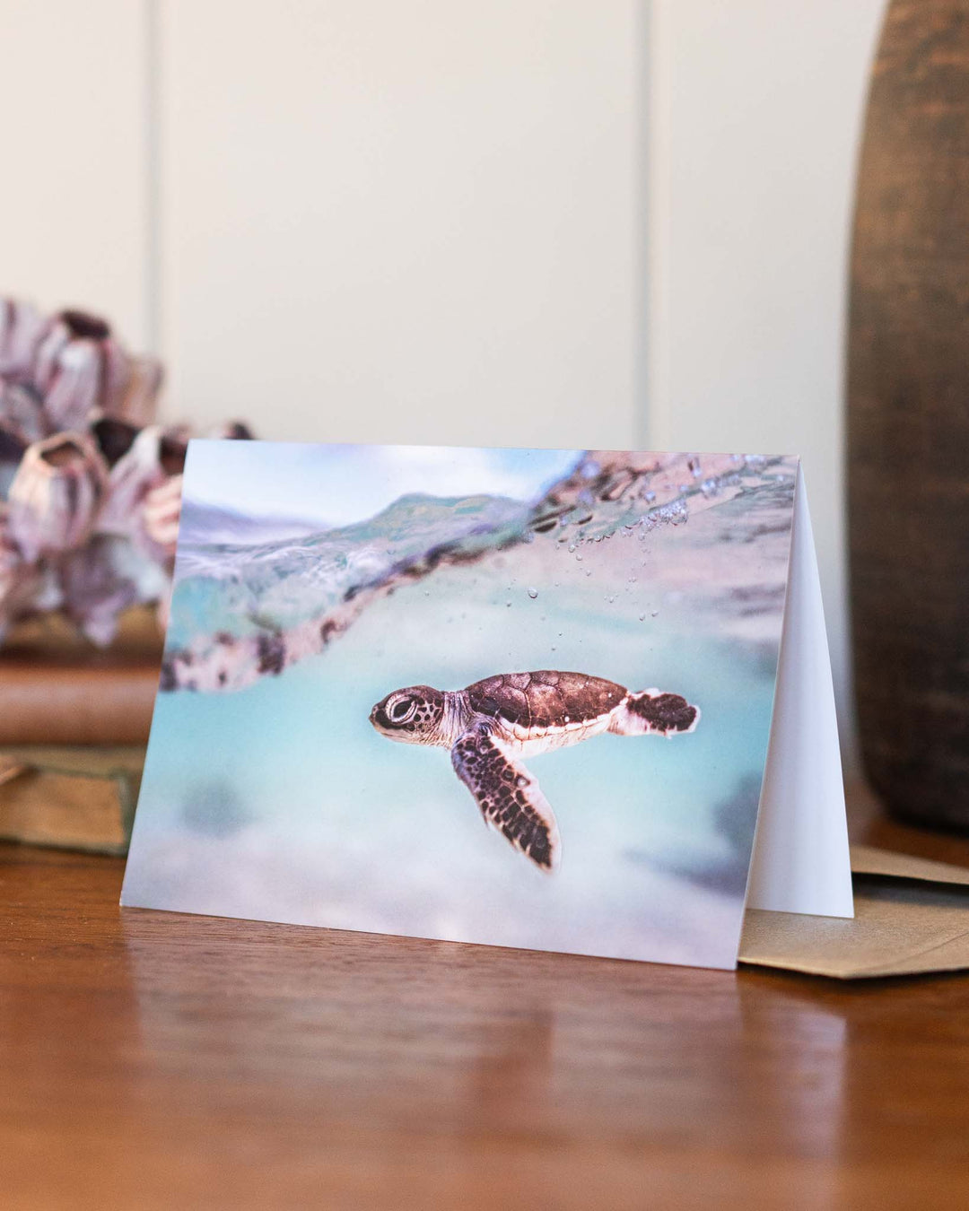 Just Keep Swimming card with a baby sea turtle illustration, designed by David Lloyd Photography.