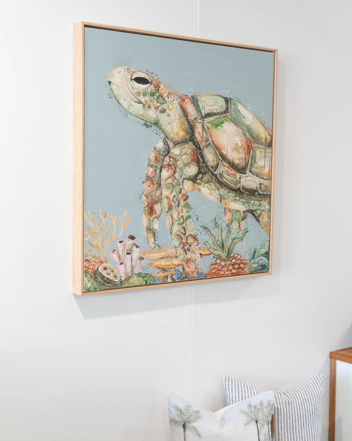 Lazy Days on Coral Cays: sea turtle swimming over coral, artwork displayed on palm tree print pillows.