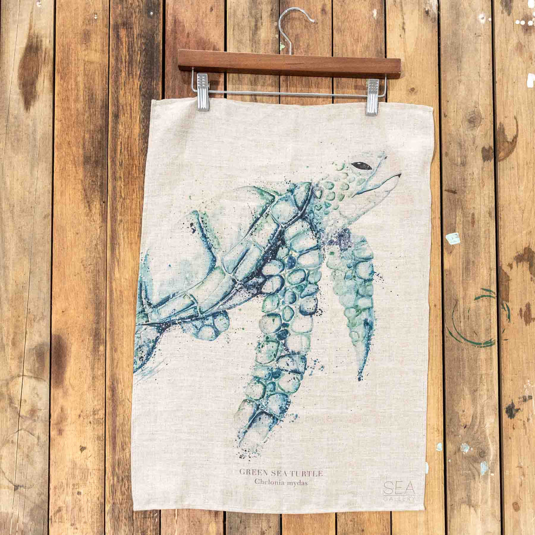 Turtle Linen Tea Towel featuring a watercolor sea turtle design by Stephanie Elizabeth Artwork on natural linen fabric.