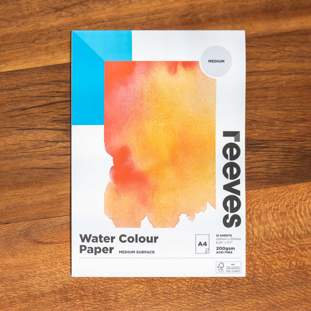 SEA Gallery Reeves Trace Paper A5 pad featuring an orange-yellow swatch on its cover, resting on a wooden table.