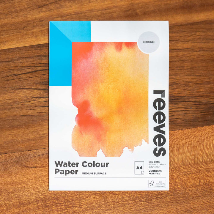 SEA Gallery Reeves Trace Paper A5 pad featuring an orange-yellow swatch on its cover, resting on a wooden table.