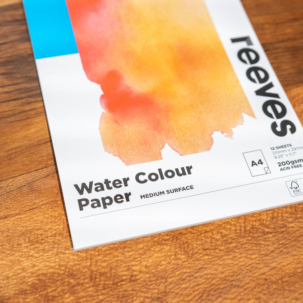 SEA Gallery Reeves Trace Paper A5 pad with translucent sheets and an orange swatch on the cover, resting on a wooden surface.