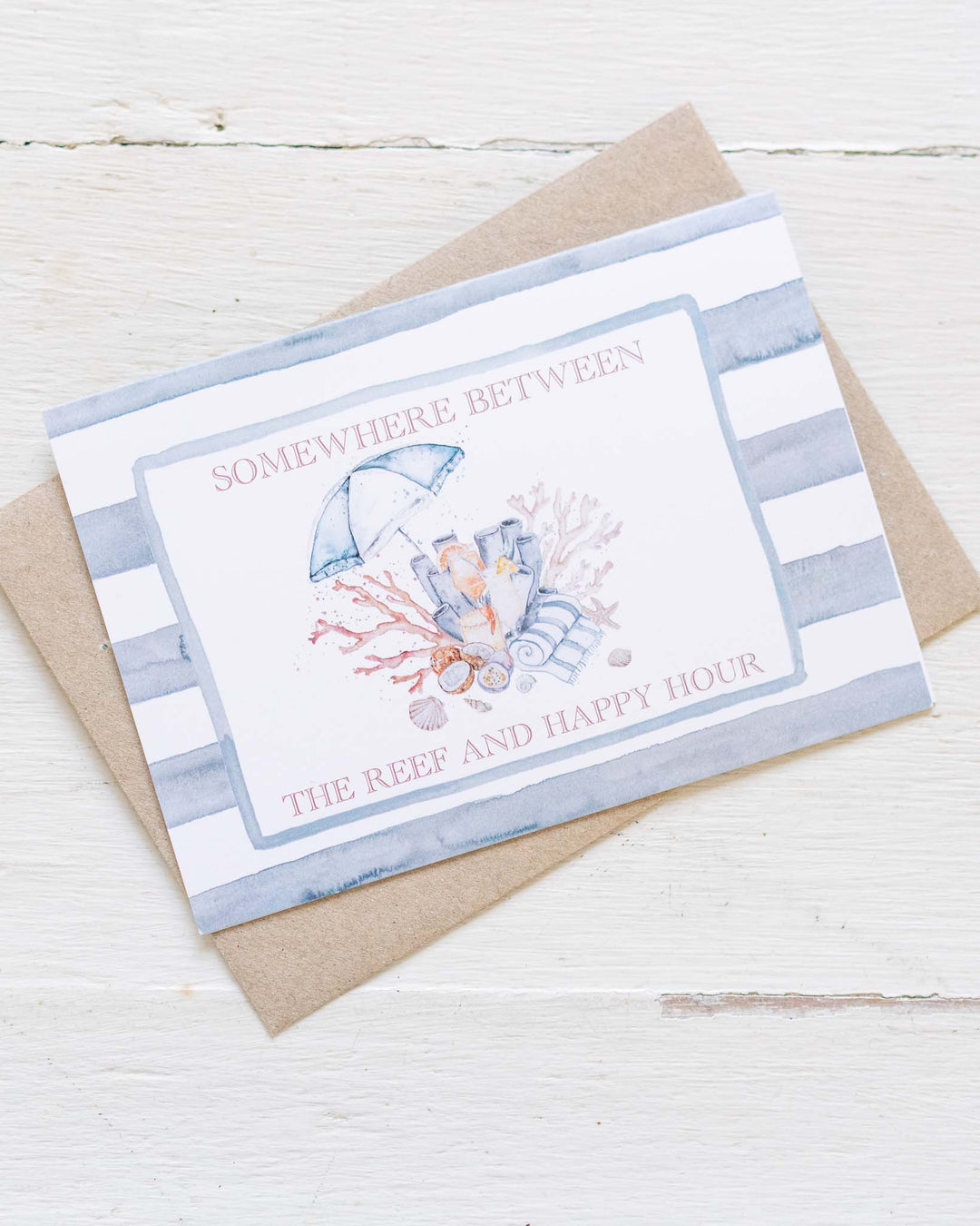 “Somewhere Between the Reef and Happy Hour” card with a matching striped envelope.