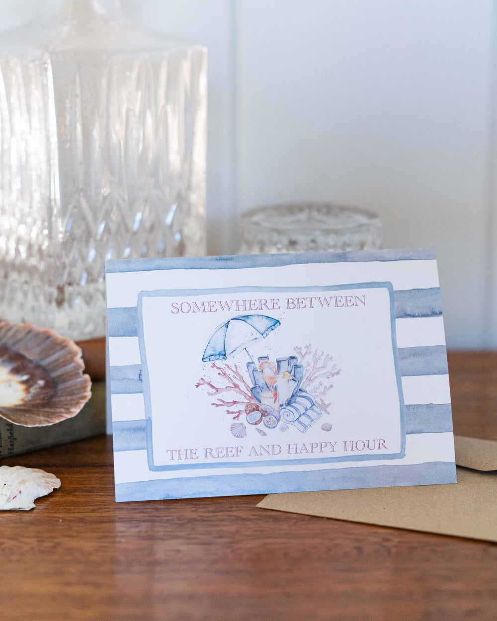 Greeting card titled “Somewhere Between the Reef and Happy Hour” with a watercolor beach scene.