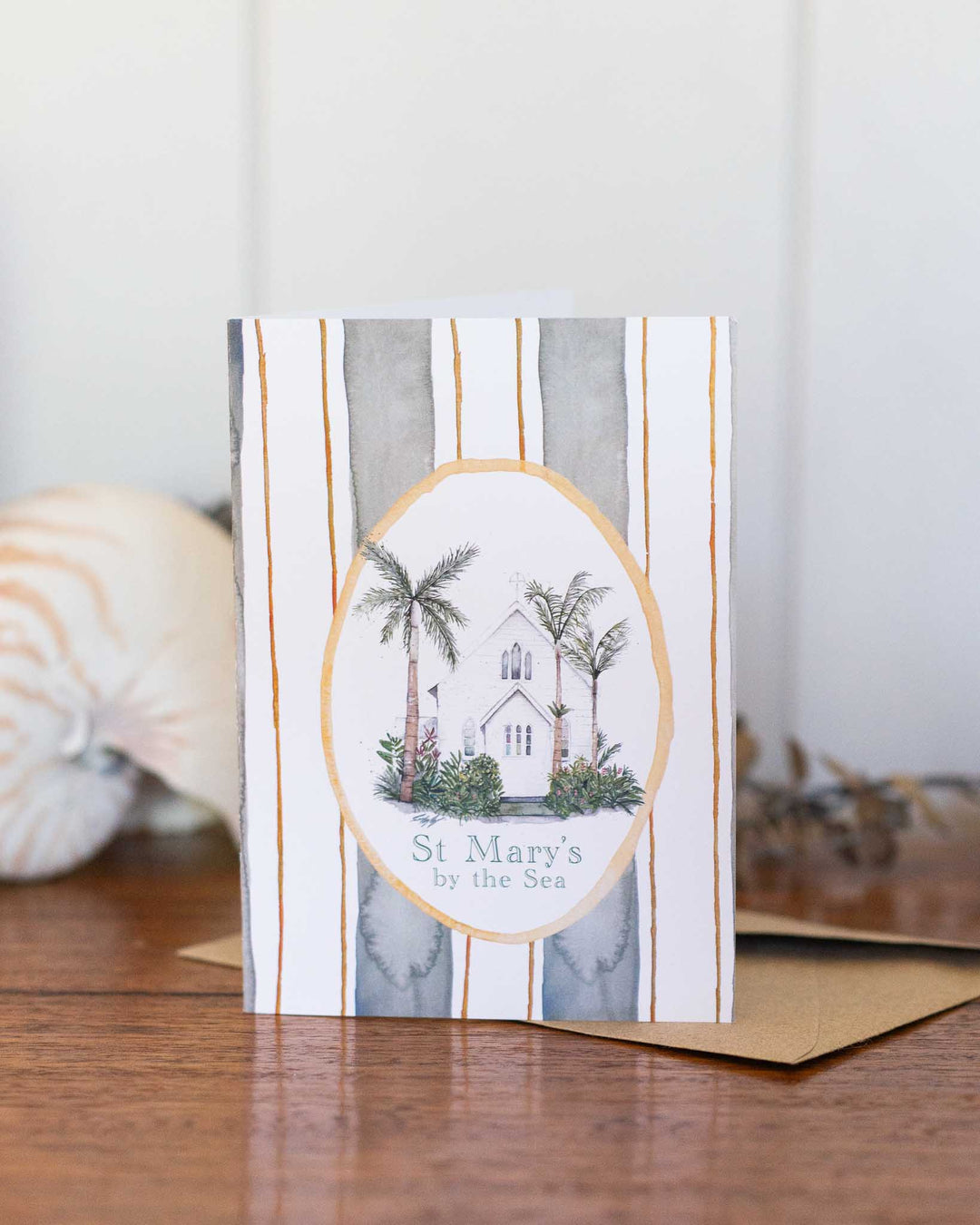 St Mary’s By the Sea Greeting Card featuring a watercolor church, palm trees, and soft striped background.