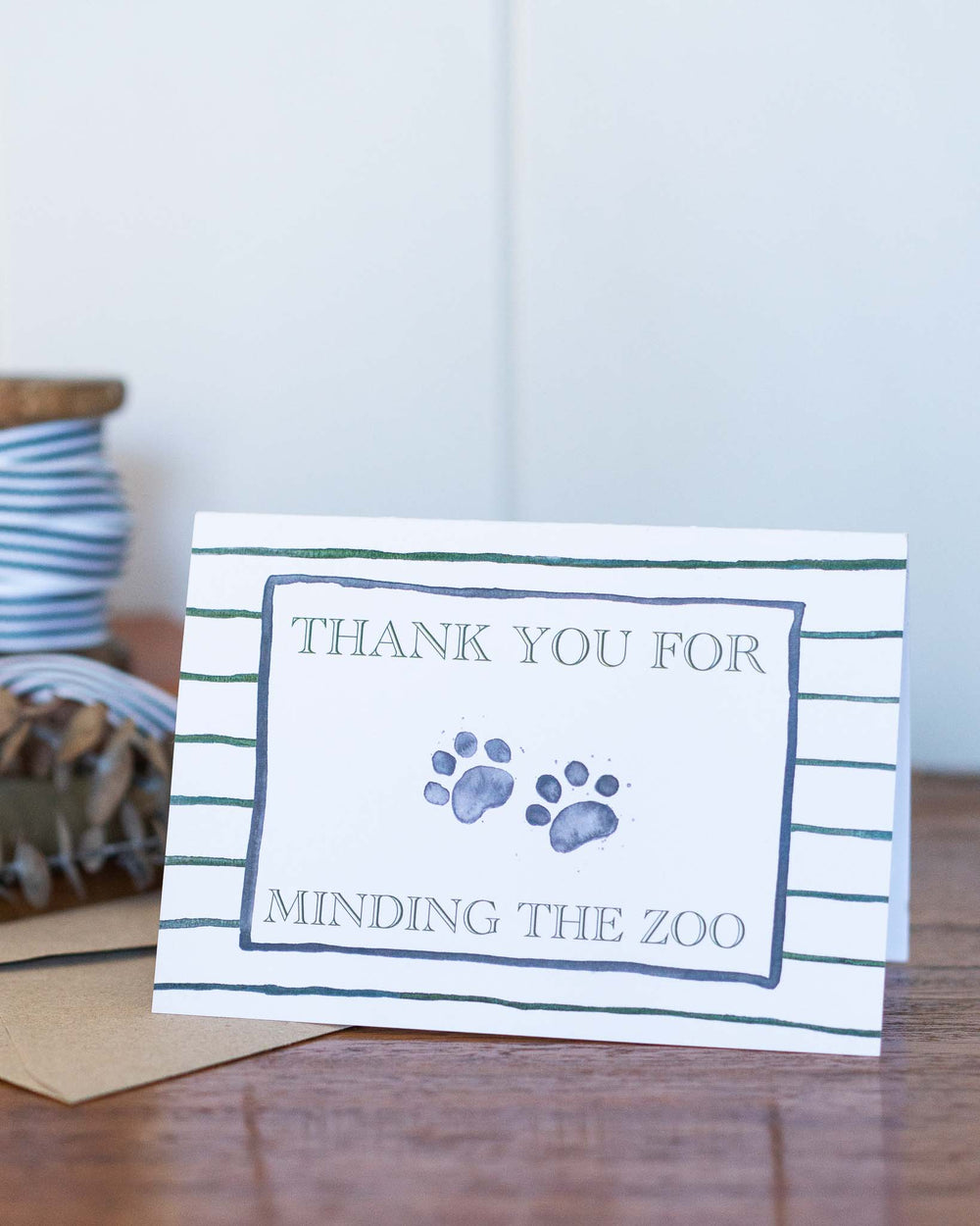 Thank You For Minding The Zoo greeting card with watercolor paw prints and playful handwritten text.