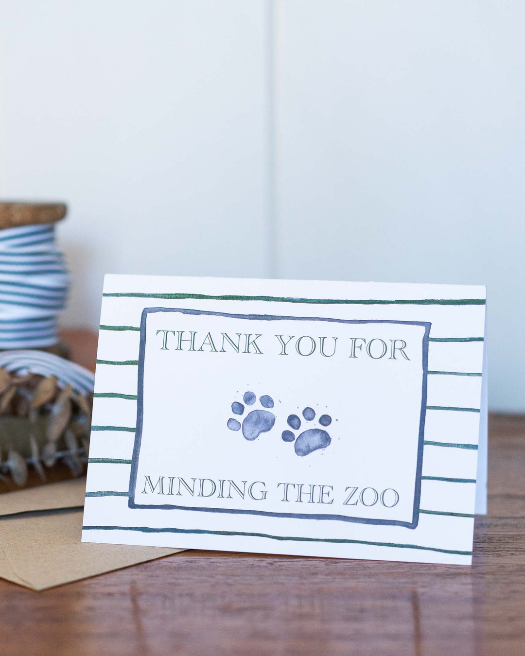 Thank You For Minding The Zoo greeting card with watercolor paw prints and playful handwritten text.