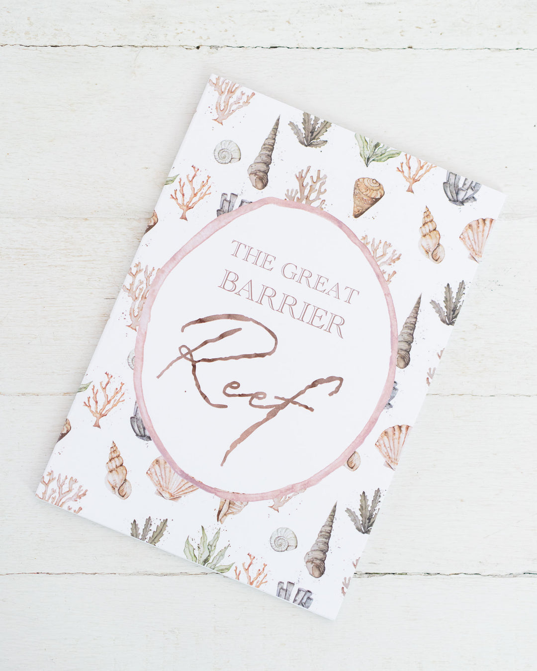 The Great Barrier Reef A5 lined notebook with seashell and coral illustrations on a white background.