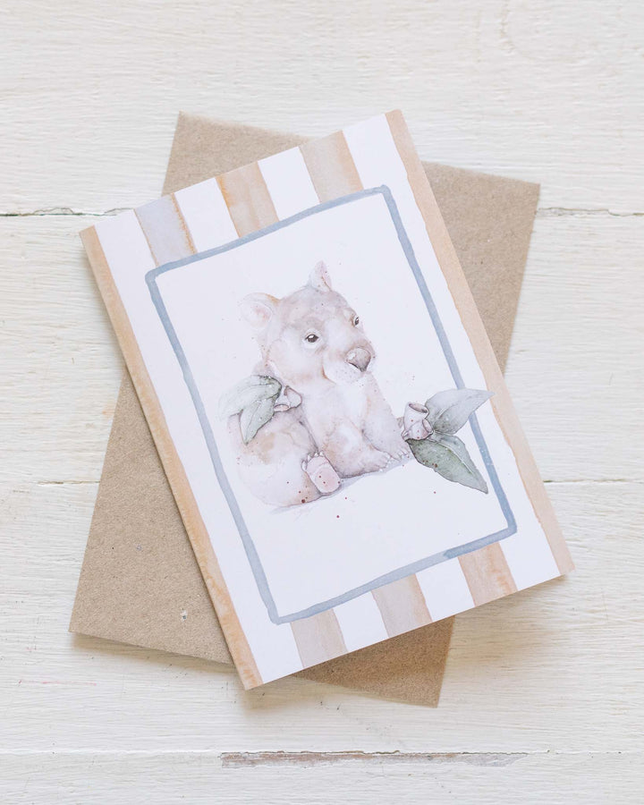 Wombat Woddle greeting card with striped baby wombat illustration and brown envelope.