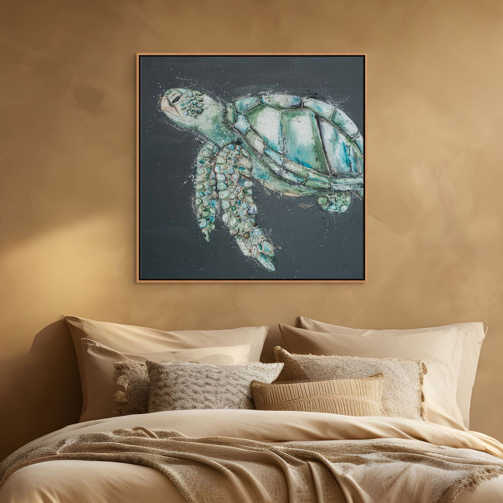 Framed artwork of a turtle on a wall above a bed with beige bedding - close up