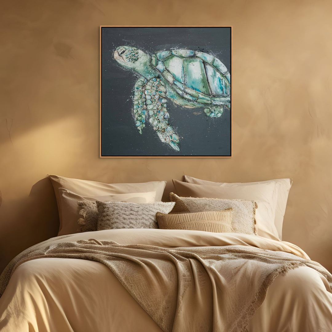 Framed artwork of a turtle on a wall above a bed with beige bedding.