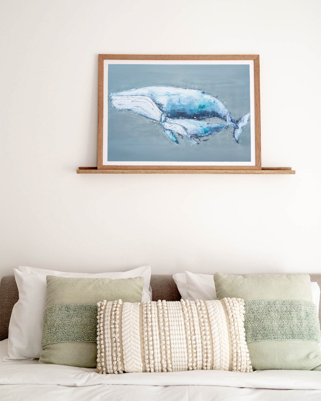 A Life Growing Together humpback whales fine art print by Stephanie Elizabeth, framed paper print in an oak frame in a bedroom