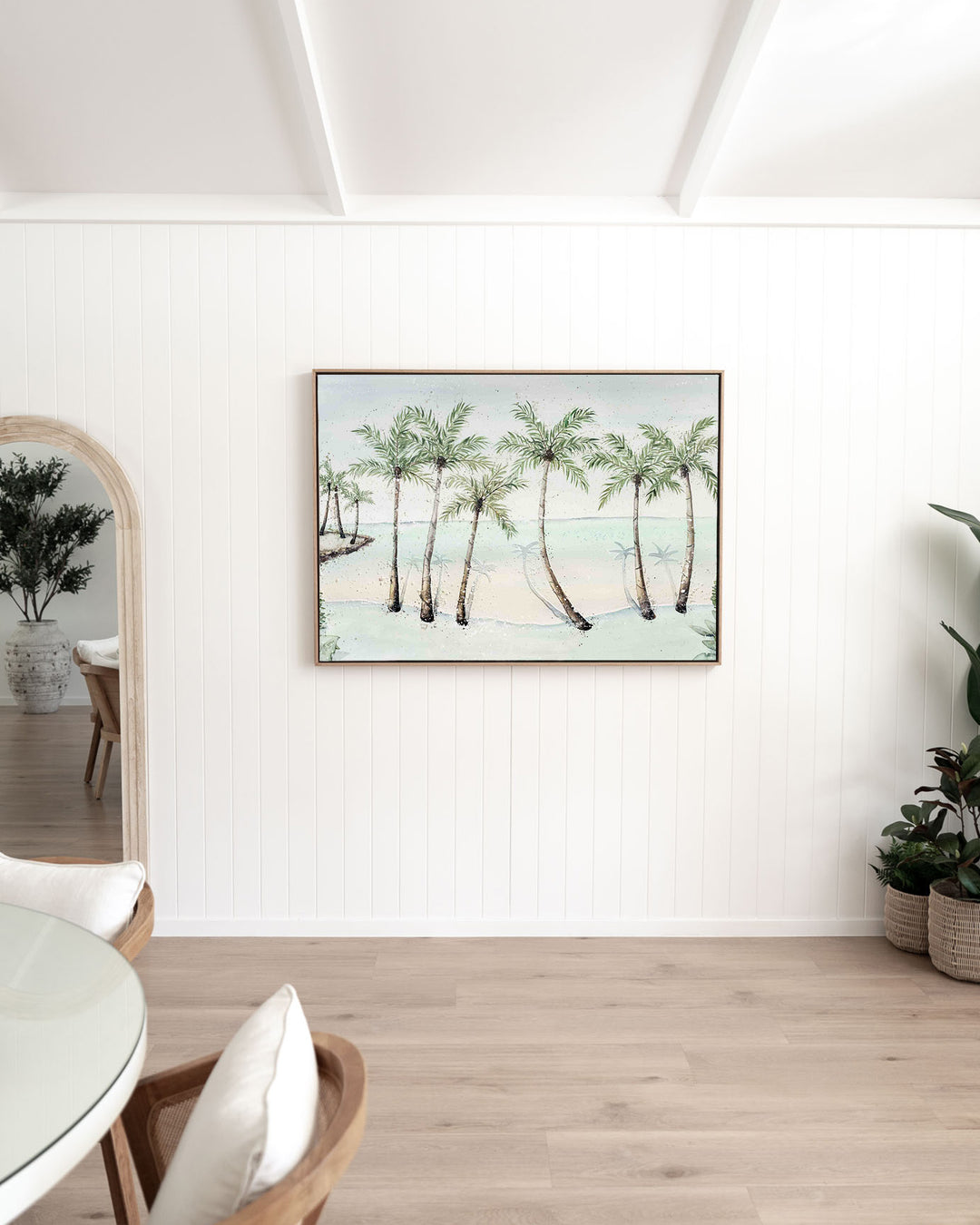 A Little Cove Love Story Port Douglas landscape fine art print by Stephanie Elizabeth, framed canvas in an oak frame in a dining room