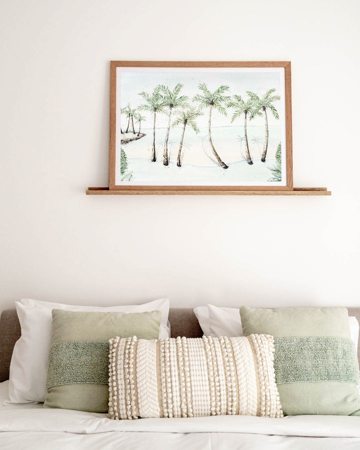 A Little Cove Love Story Port Douglas landscape fine art print by Stephanie Elizabeth, framed paper print in an oak frame in a bedroom