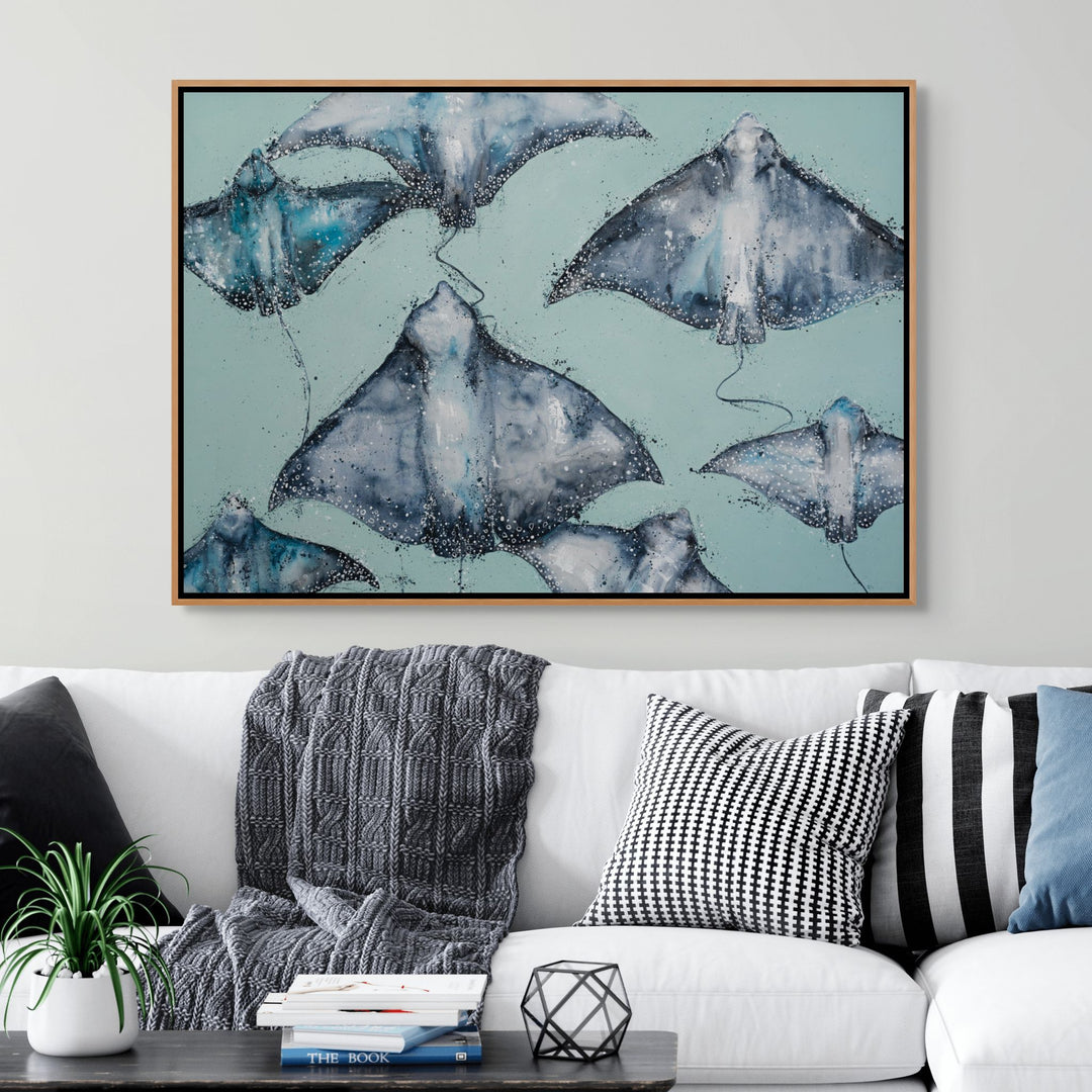 A Sea of Spots by Stephanie Elizabeth – shadow box canvas print of eagle rays swimming across teal background, ocean-inspired artwork