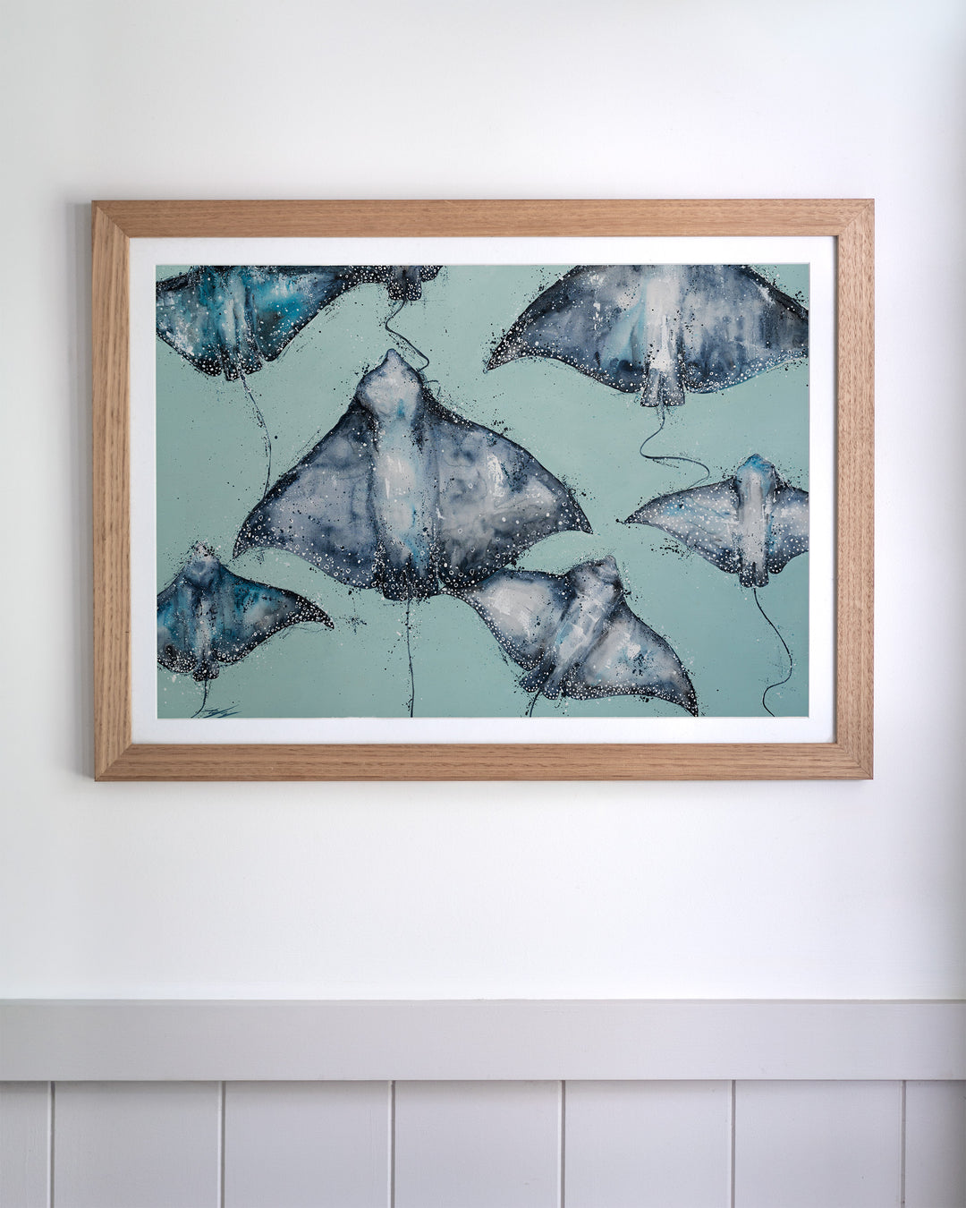 A Sea of Spots eagle rays fine art print by Stephanie Elizabeth, framed paper print in an oak frame