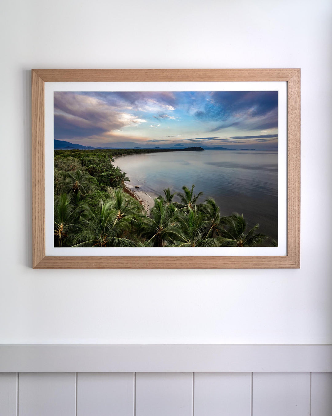 Aerial photograph of the tropical Four Mile Beach in Port Douglas under a cloudy sky, titled Framed After The Storm.