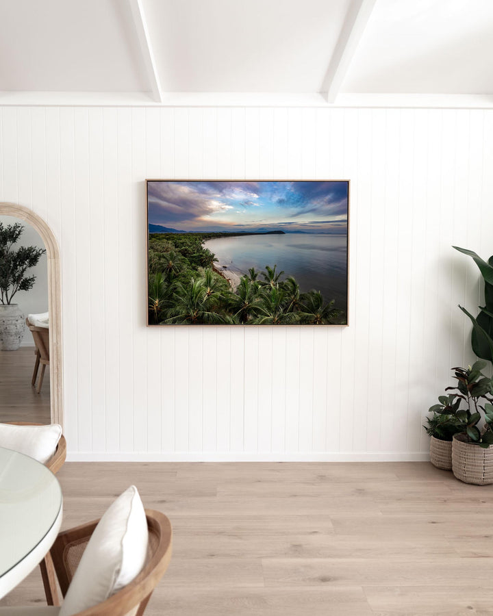 Framed After The Storm print of the tropical coastline at Four Mile Beach, Port Douglas, displayed on a white wall.