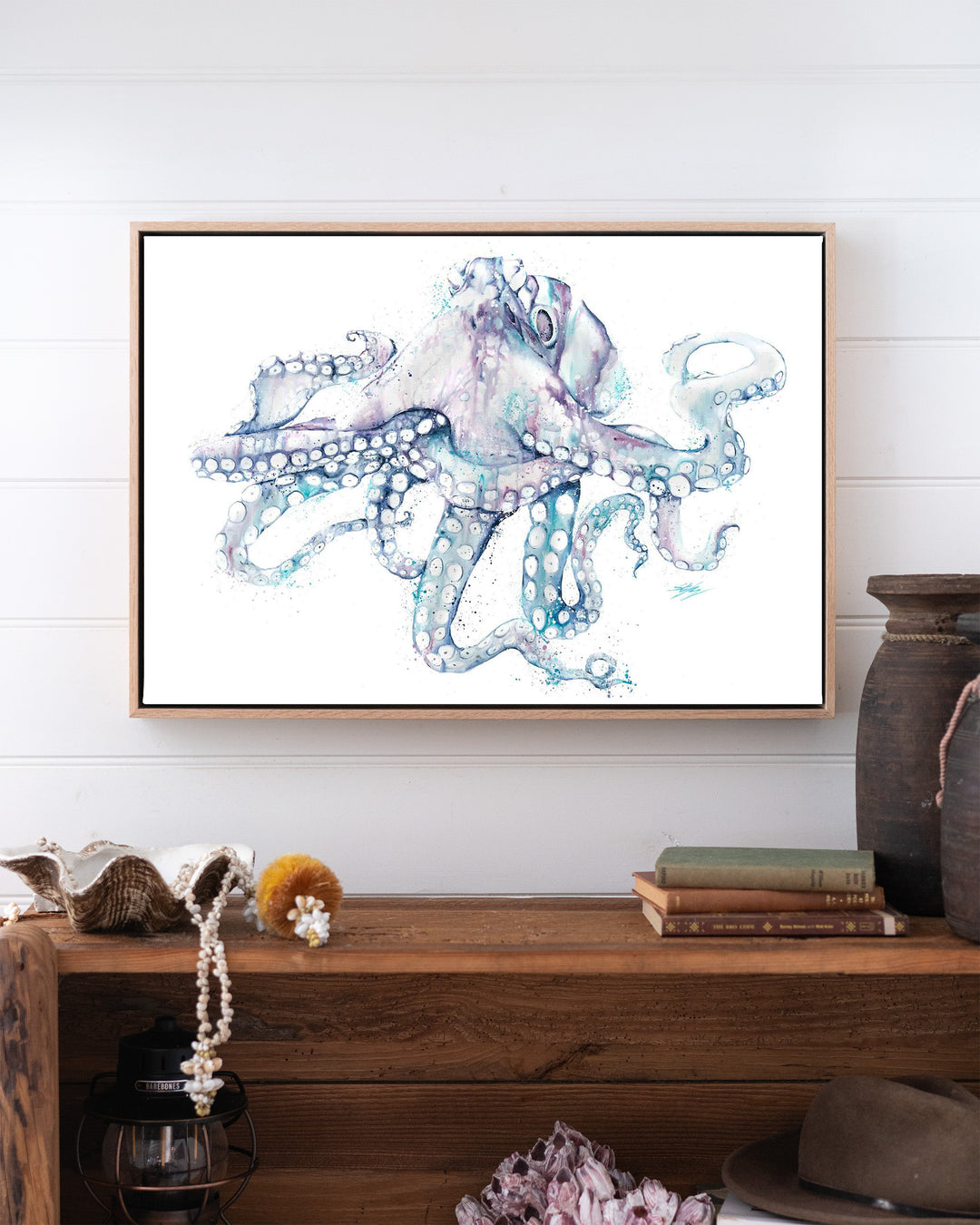 All Legs and No Worries octopus fine art print by Stephanie Elizabeth, framed canvas in an oak frame above a bookshelf