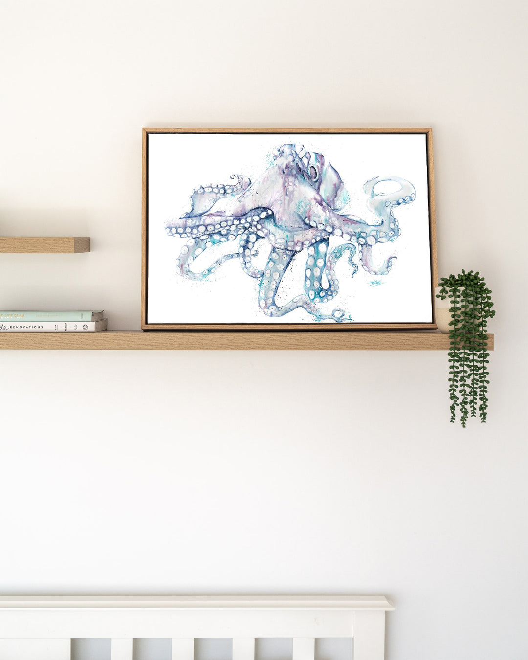 All Legs and No Worries octopus fine art print by Stephanie Elizabeth, framed canvas in an oak frame on a shelf