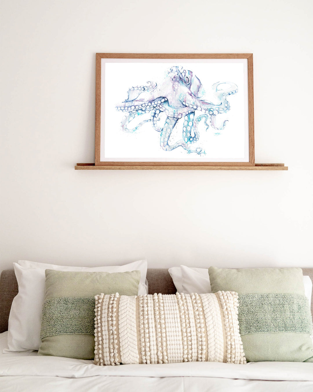 All Legs and No Worries octopus fine art print by Stephanie Elizabeth, framed paper print in an oak frame in a bedroom