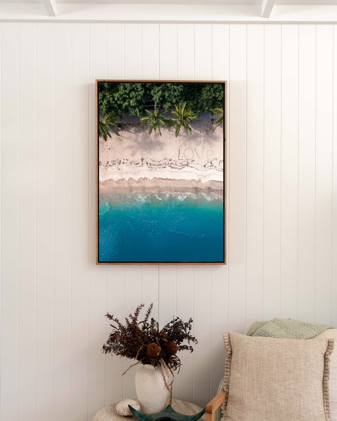 All You Need Is... – Whitsundays, Aerial Photography by David Lloyd, framed canvas print in oak float frame, styled in a bedroom setting
