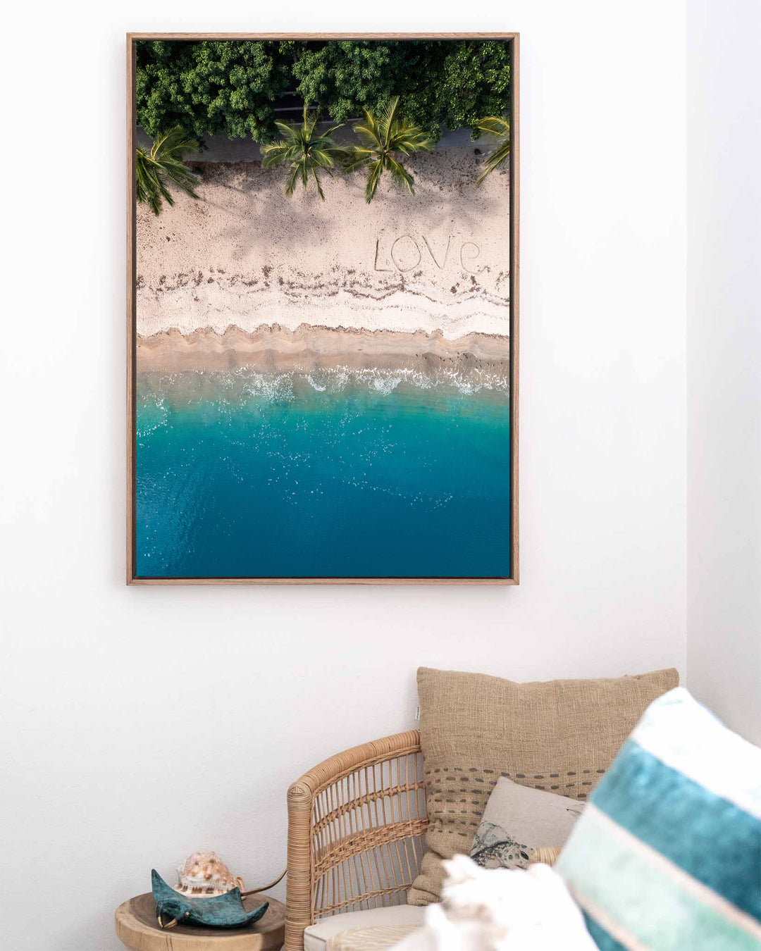 All You Need Is... – Whitsundays, Aerial Photography by David Lloyd, framed canvas print in oak float frame, styled in a coastal lounge setting