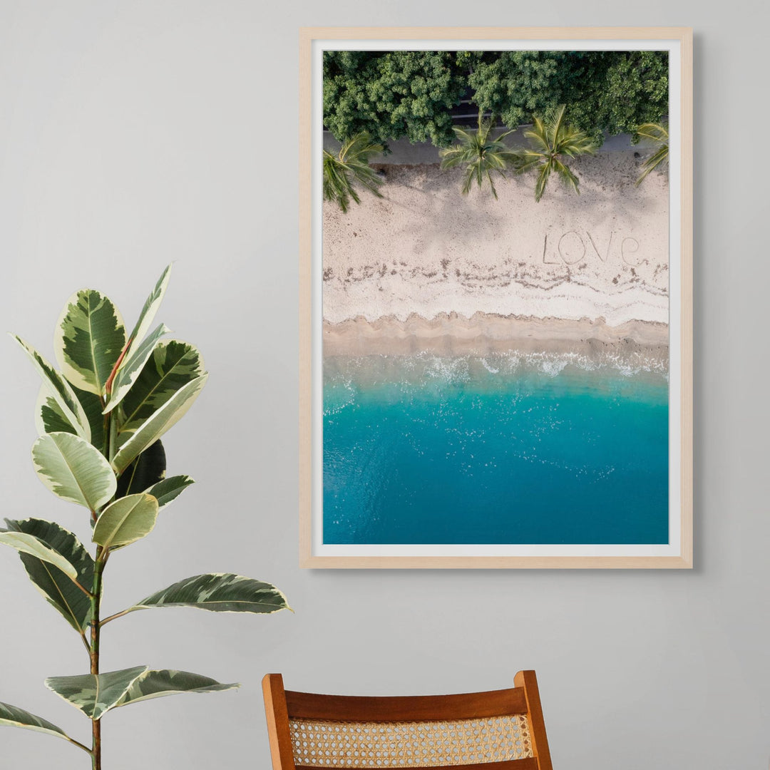 All You Need Is… – Aerial view of the Whitsundays with “Love” written on the beach, turquoise water and palm trees above and below | Framed Paper Print