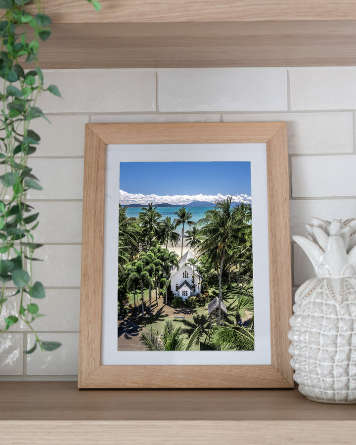 Always Forever – St Mary’s, Port Douglas, Aerial Photography by David Lloyd, framed paper print in oak frame, styled in a kitchen shelf setting