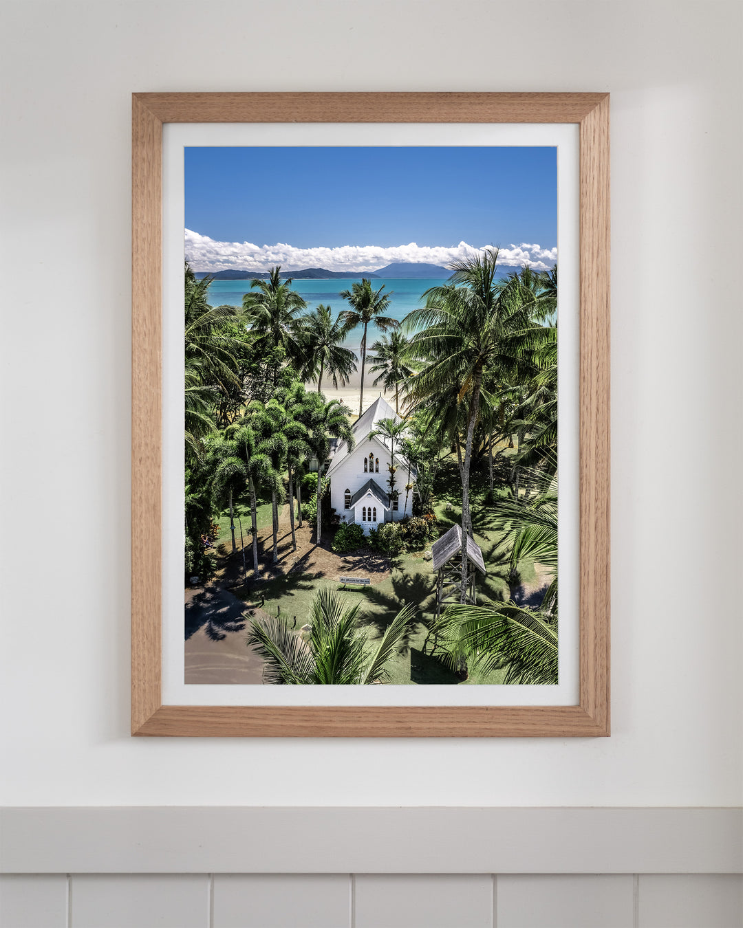 Framed Always Forever aerial print of the white St Mary’s church surrounded by tropical palm trees in Port Douglas.