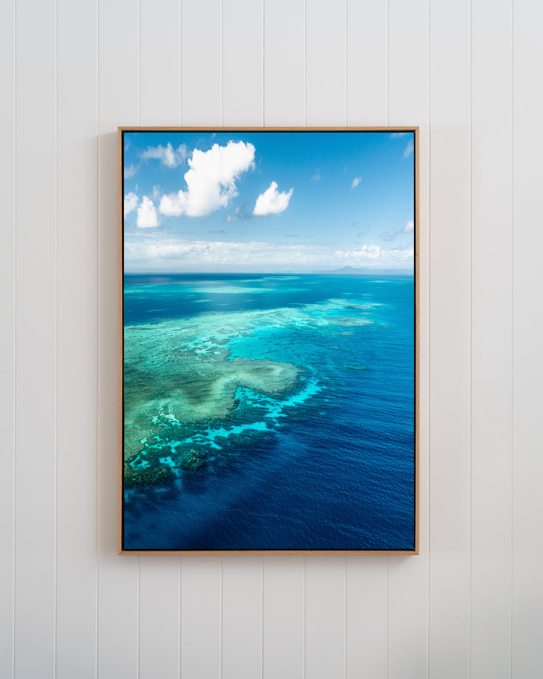 Framed aerial photo titled Always Take The Weather With You by Rudder Reef, showing a turquoise reef meeting deep blue sea.