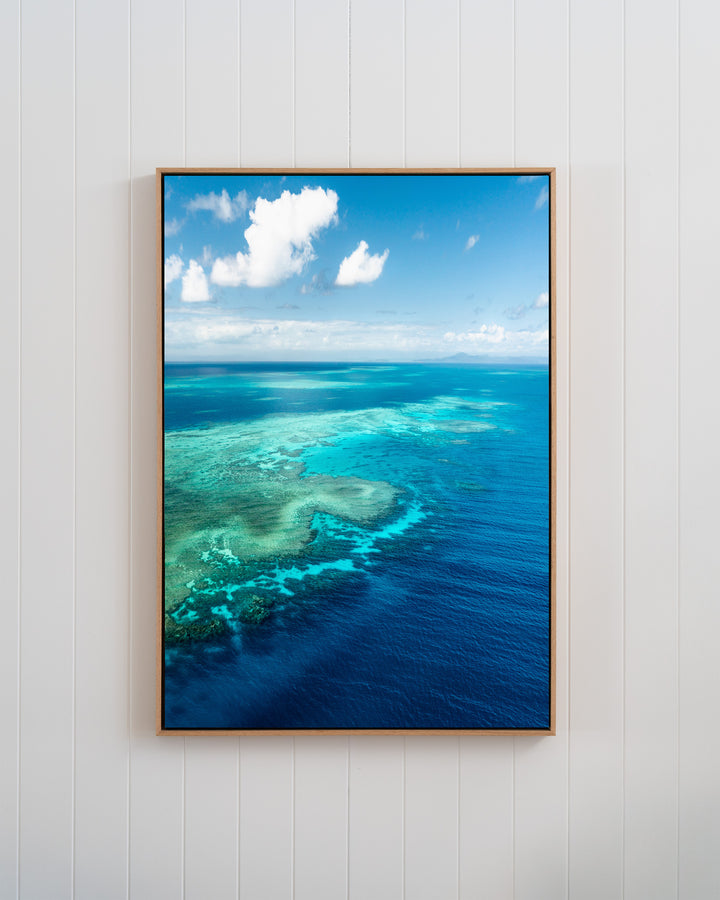 Framed aerial photo titled Always Take The Weather With You by Rudder Reef, showing a turquoise reef meeting deep blue sea.