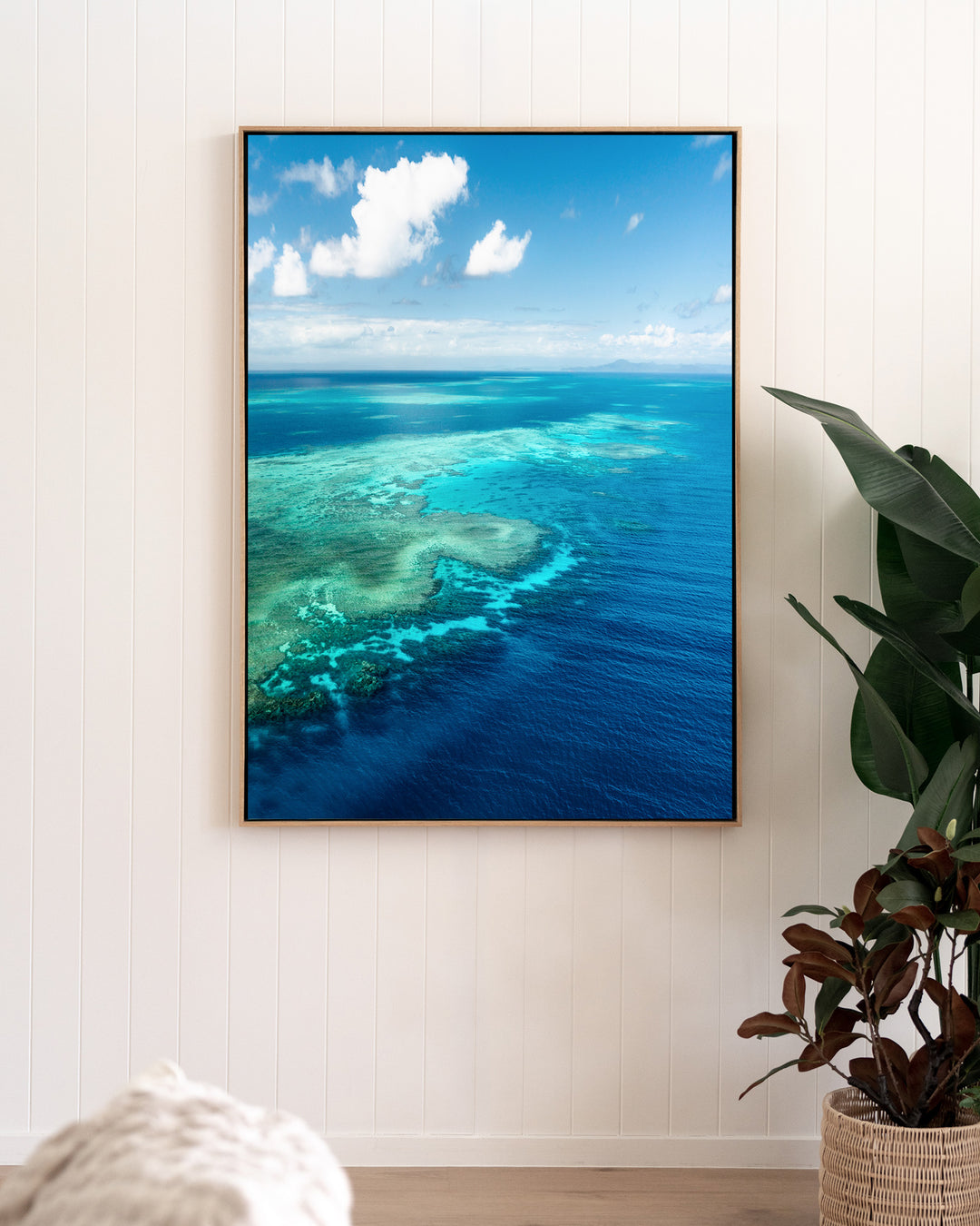 Always Take The Weather With You – Rudder Reef, Aerial Photography by David Lloyd, framed canvas print in oak float frame, styled in a living room setting