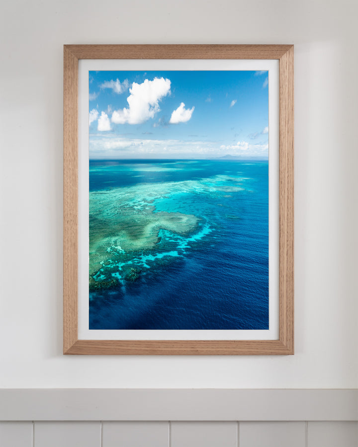 Framed Always Take The Weather With You by Rudder Reef, featuring a coral reef in turquoise water under a cloudy sky.